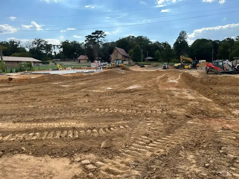 Large site graded flat with equipment working in the background