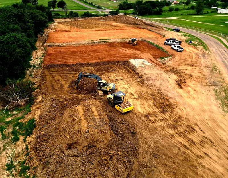 Aerial view of a graded building pad and site prep job cut into red dirt by Circle H crews