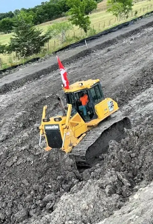 Dozer flying a flag while working a rocky slope