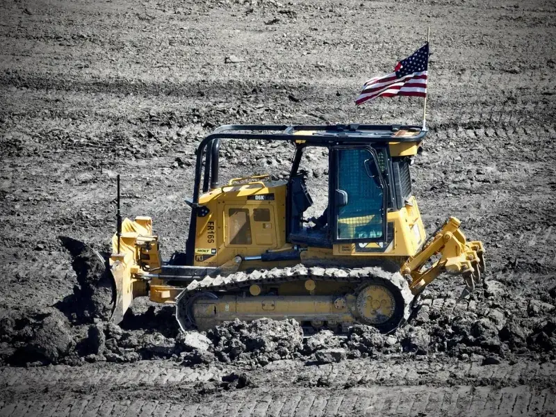 Circle H dozer flying an American flag on a job site