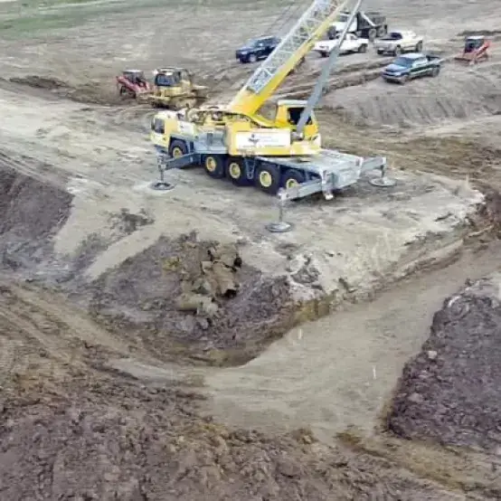Aerial view of a crane working on a large construction site